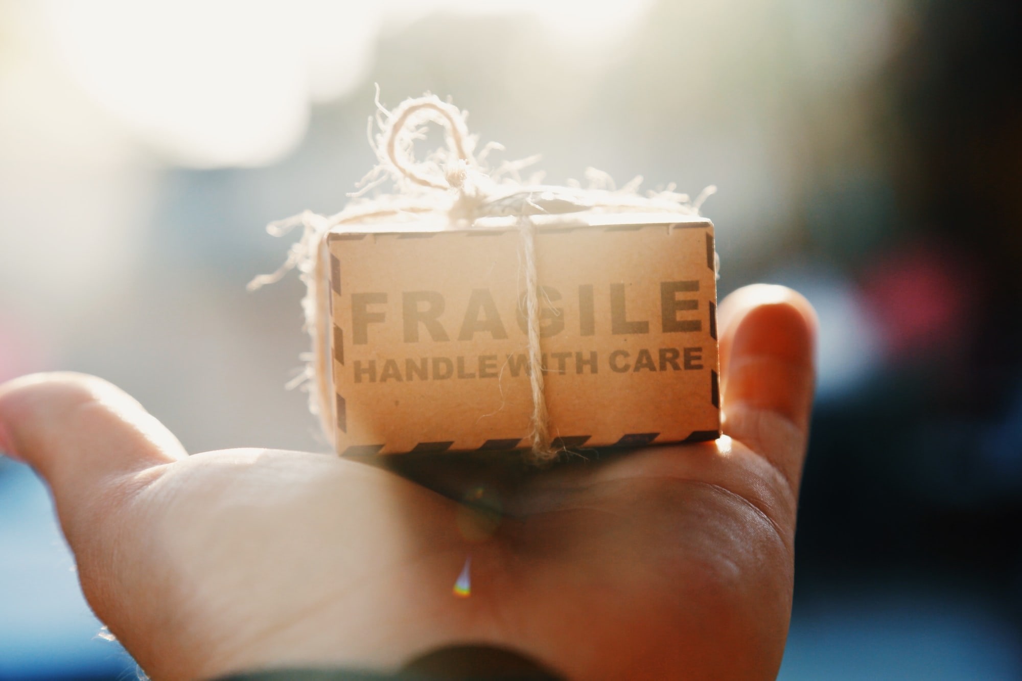 Fragile handle with care, photo of a box wrapped in twine.